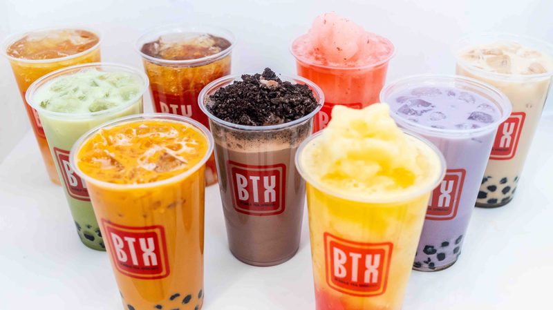 Nine colorful BTX Cafe drinks lined up on the counter